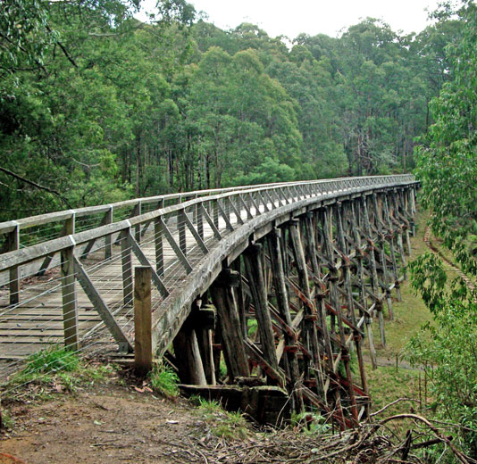 Image of a curving wooden trestle bridge